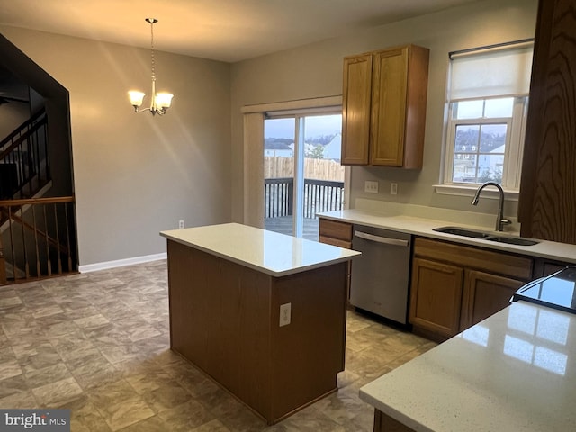 kitchen featuring a sink, light countertops, dishwasher, a notable chandelier, and a center island