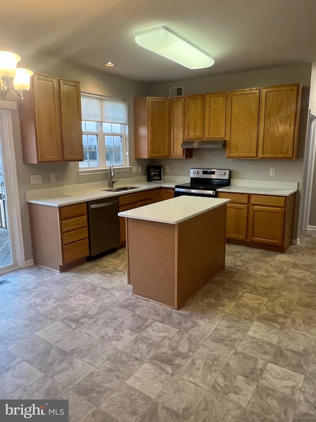 kitchen featuring visible vents, a sink, light countertops, appliances with stainless steel finishes, and under cabinet range hood