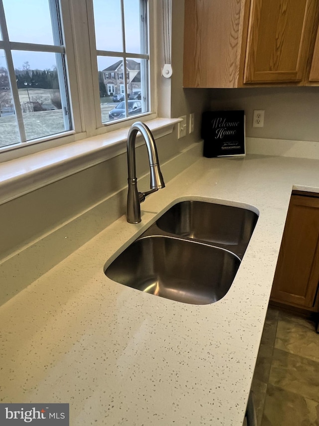 interior details featuring brown cabinets and a sink