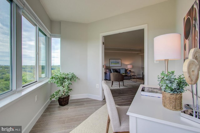 office space featuring light wood-type flooring and baseboards