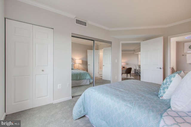 carpeted bedroom with baseboards, two closets, visible vents, and crown molding