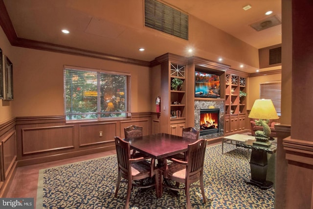 dining room featuring recessed lighting, a wainscoted wall, visible vents, a lit fireplace, and ornamental molding