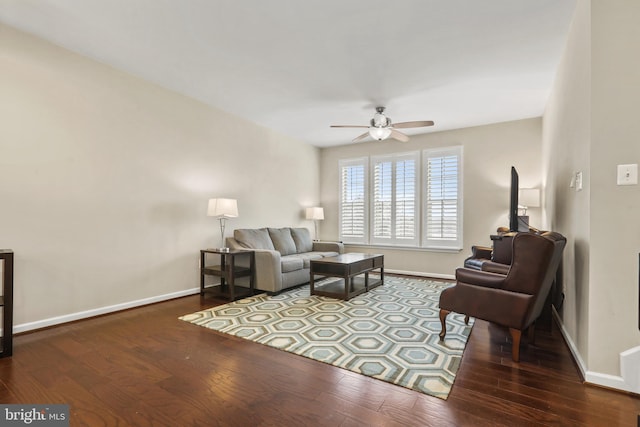 living room with dark wood-type flooring and ceiling fan