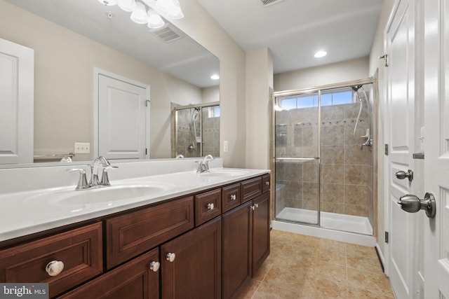 bathroom featuring vanity, tile patterned floors, and a shower with door