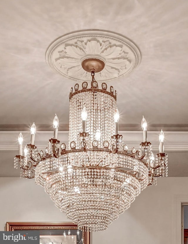 details featuring ornamental molding and a chandelier