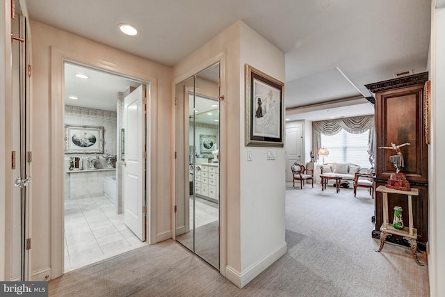 corridor with visible vents, baseboards, light colored carpet, and recessed lighting
