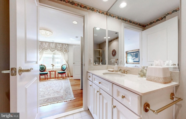 full bathroom with wood finished floors, vanity, a shower with door, and recessed lighting