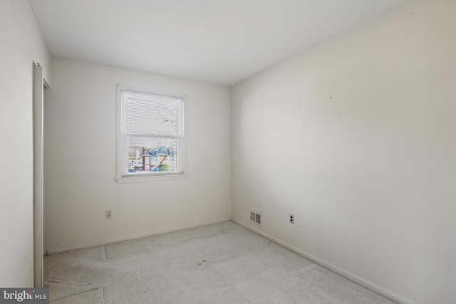 carpeted spare room with visible vents