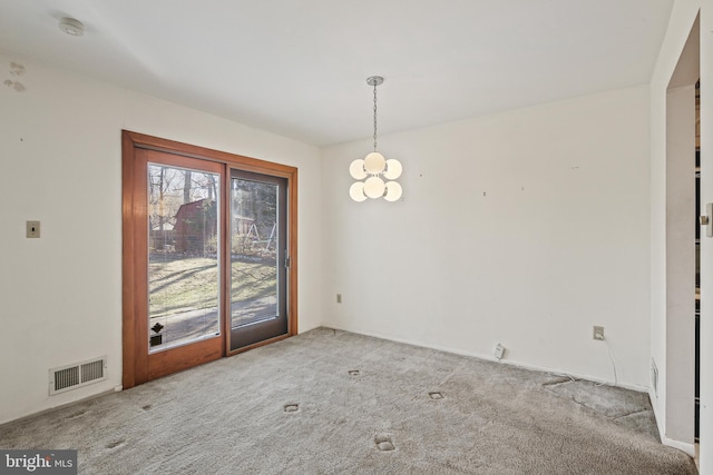 unfurnished dining area with carpet floors, visible vents, and a notable chandelier