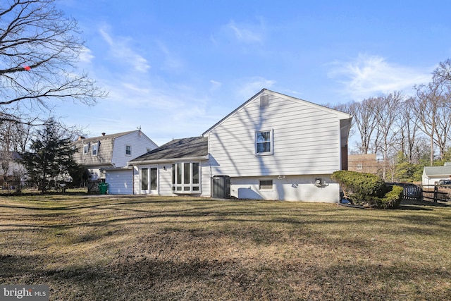 back of house with central AC unit, a lawn, and fence