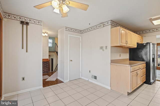 kitchen with light tile patterned floors, visible vents, refrigerator with ice dispenser, and light brown cabinetry