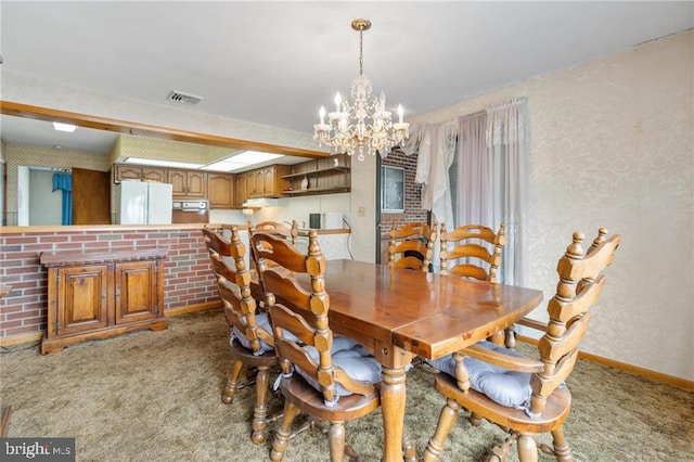 carpeted dining room featuring a notable chandelier