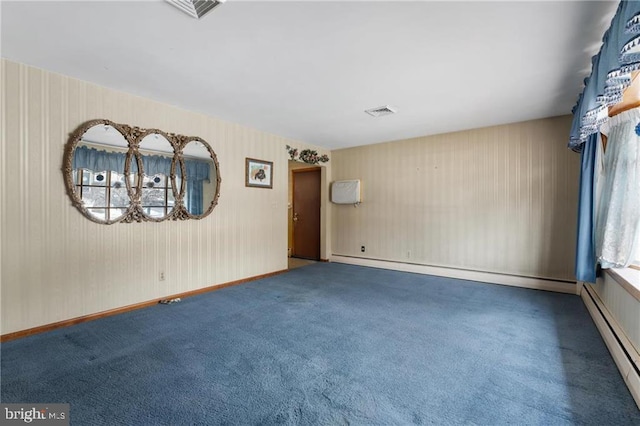 unfurnished room with a notable chandelier, carpet flooring, and a baseboard heating unit