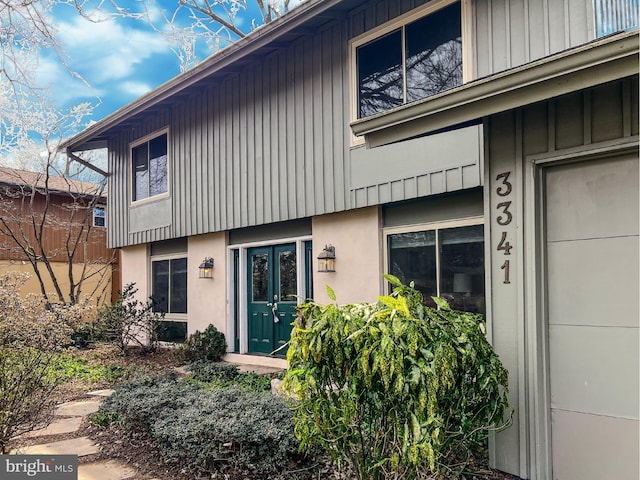 view of exterior entry featuring board and batten siding