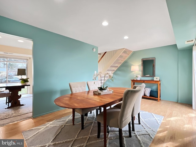 dining space featuring recessed lighting, visible vents, light wood finished floors, and stairs