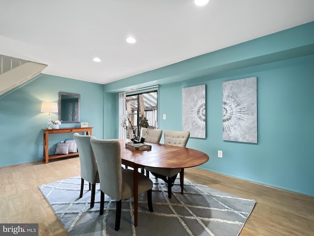 dining space with wood finished floors and recessed lighting