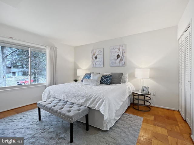 bedroom with baseboards and a closet