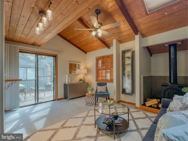 living area featuring wooden ceiling, baseboards, lofted ceiling with beams, and a wood stove