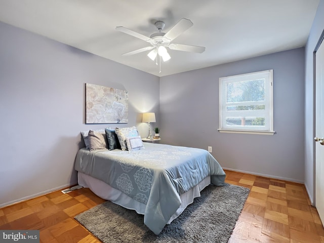 bedroom featuring ceiling fan and baseboards