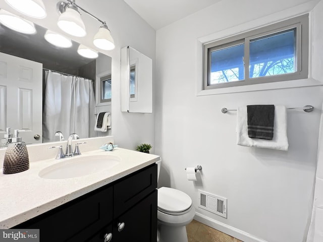 full bath featuring visible vents, toilet, vanity, tile patterned flooring, and baseboards