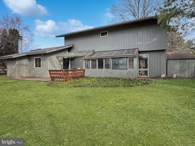 back of property featuring a yard, a patio, and an outdoor structure