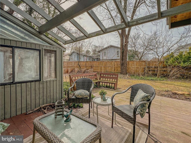 wooden terrace featuring a fenced backyard and a pergola