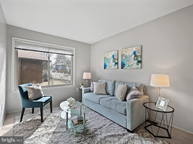 carpeted living room featuring baseboards