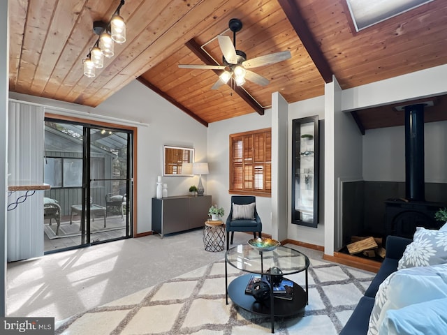 interior space with a wood stove, wooden ceiling, baseboards, and vaulted ceiling