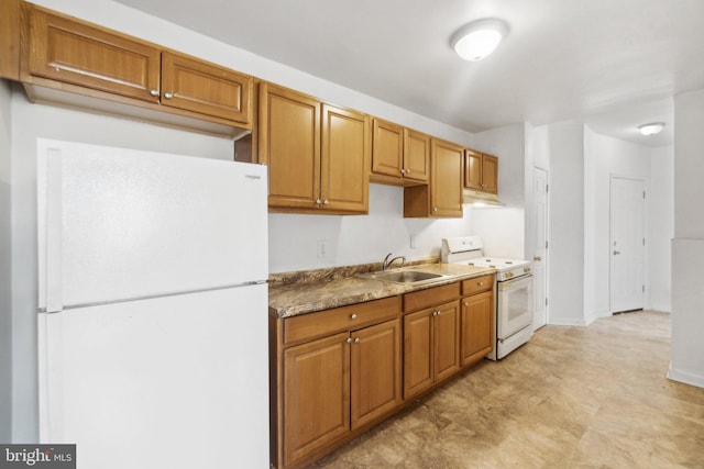 kitchen with baseboards, white appliances, a sink, and brown cabinets