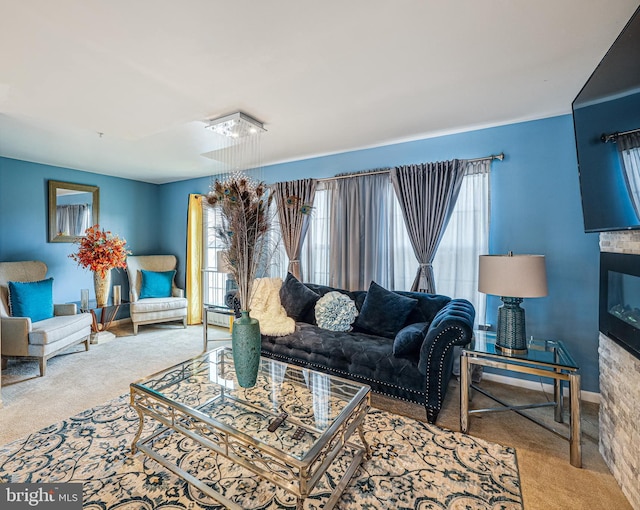 living area with a healthy amount of sunlight, carpet, baseboards, and a baseboard radiator