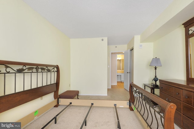 bedroom with light carpet, a textured ceiling, and baseboards