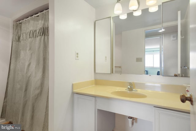 full bathroom with vanity and a shower with curtain