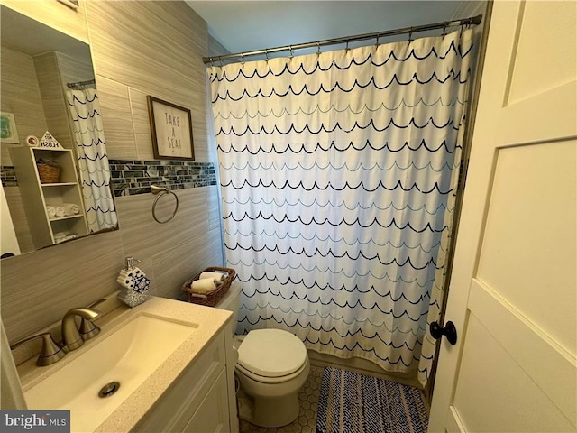 bathroom featuring vanity, tile walls, a shower with shower curtain, and toilet