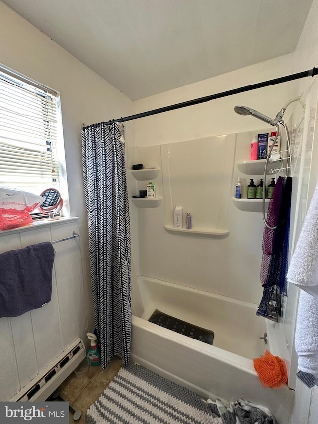 bathroom with shower / tub combo and baseboard heating