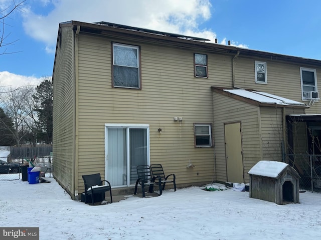 view of snow covered back of property