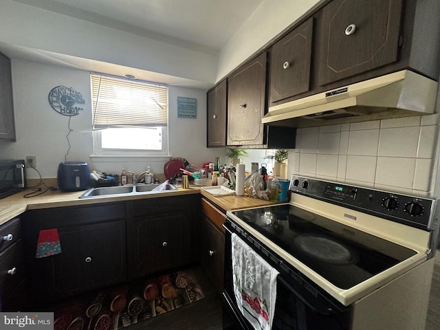 kitchen featuring decorative backsplash, black electric range oven, sink, and dark brown cabinets