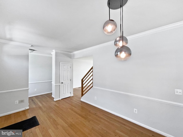 interior space with wood-type flooring and crown molding