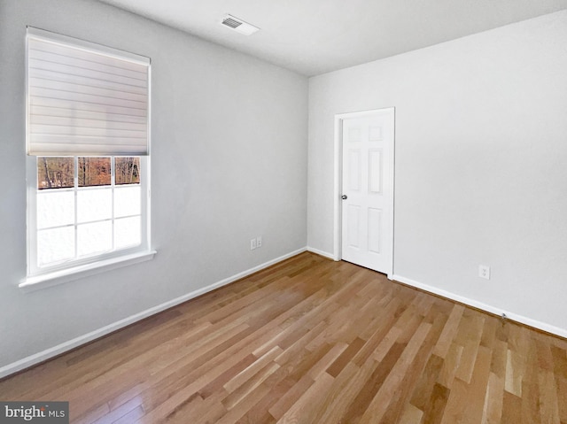 spare room with light hardwood / wood-style flooring