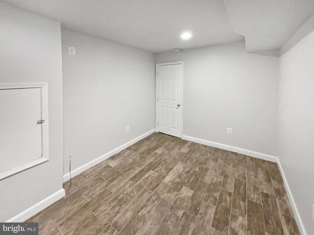 basement featuring dark hardwood / wood-style flooring