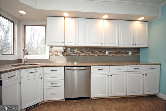 kitchen featuring decorative backsplash, white cabinetry, dishwasher, and a sink