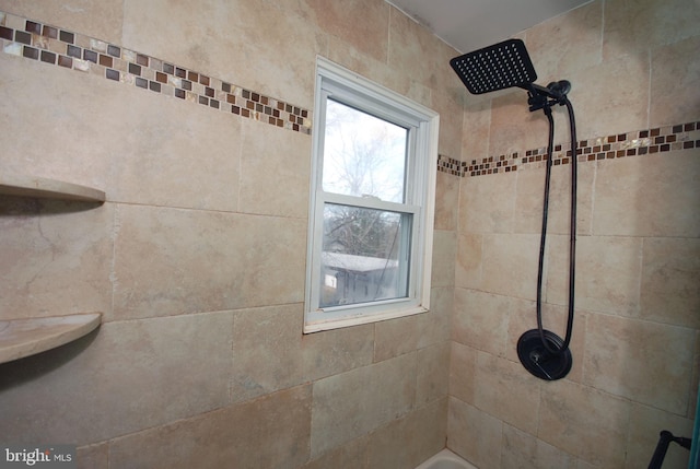 interior details with a tile shower