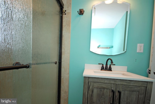 full bath with a shower with door and vanity