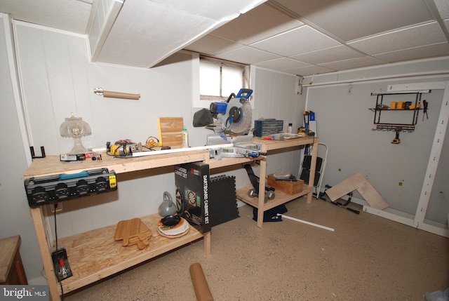 below grade area featuring a workshop area and a drop ceiling