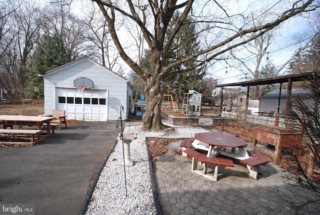 view of yard with an outbuilding, a detached garage, and fence