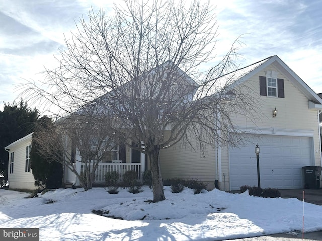 view of front of home featuring covered porch and a garage