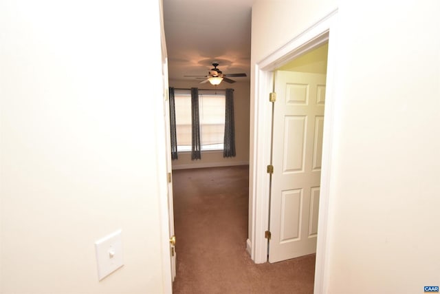 hallway featuring light colored carpet