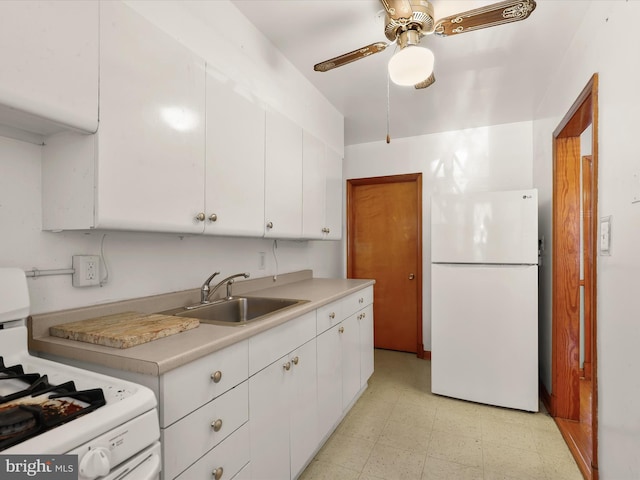 kitchen with sink, white appliances, white cabinets, and ceiling fan