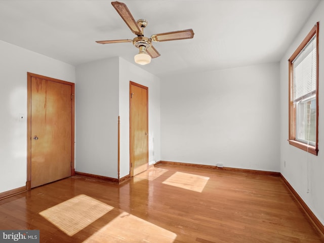 unfurnished bedroom with ceiling fan, light wood-type flooring, and a closet