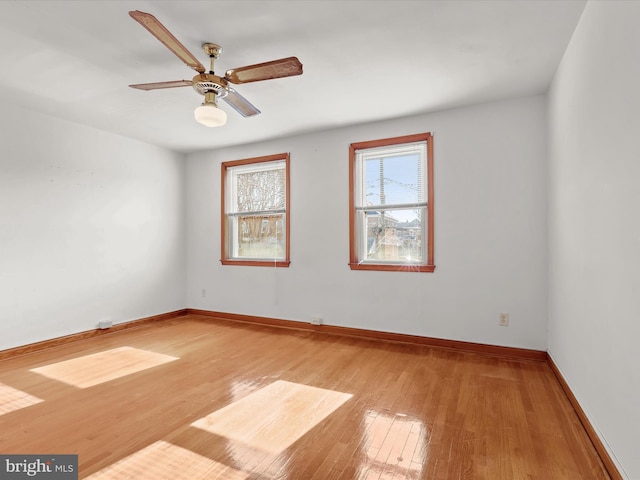 spare room with hardwood / wood-style floors and ceiling fan