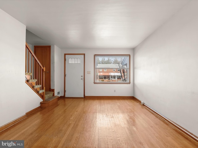 foyer entrance with light hardwood / wood-style flooring